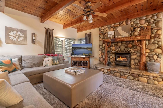 carpeted living room featuring ceiling fan, a stone fireplace, and wood ceiling