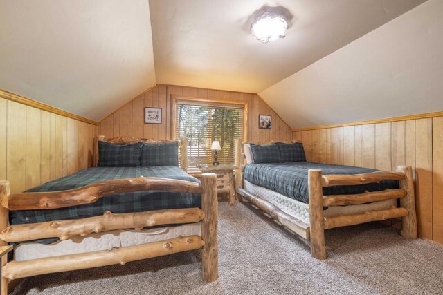 bedroom featuring light carpet, wooden walls, and vaulted ceiling