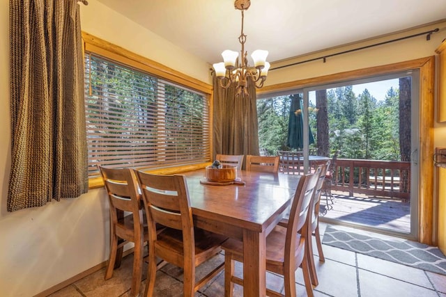 tiled dining room with an inviting chandelier