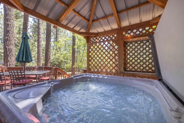 view of swimming pool featuring a hot tub, a deck, and a gazebo