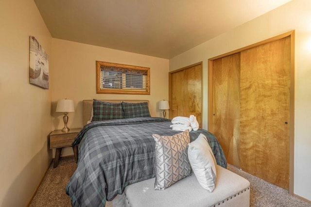 bedroom with carpet and multiple closets