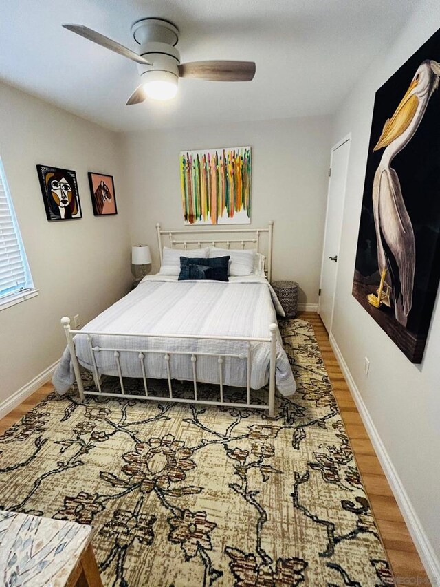 bedroom with ceiling fan and hardwood / wood-style floors