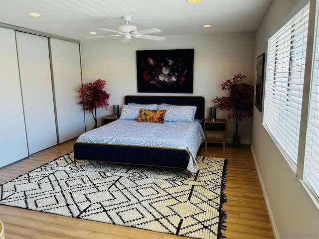 bedroom featuring a closet, hardwood / wood-style flooring, and ceiling fan