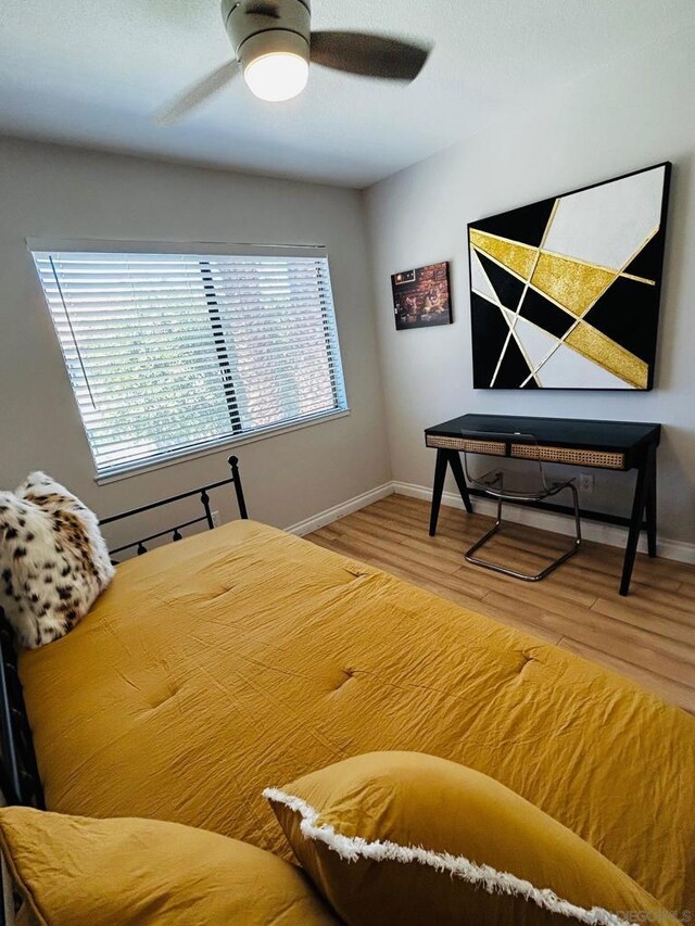 bedroom with ceiling fan and hardwood / wood-style floors