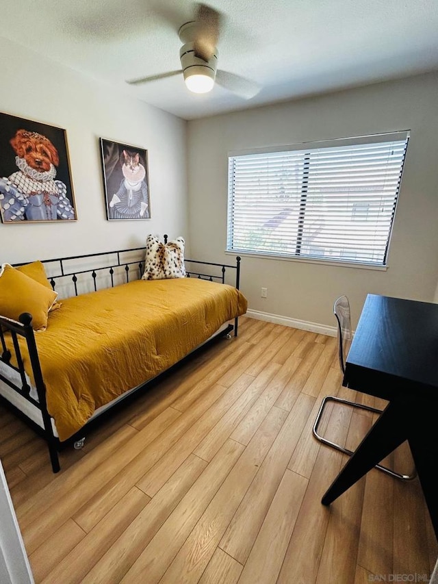 bedroom with ceiling fan and light hardwood / wood-style flooring