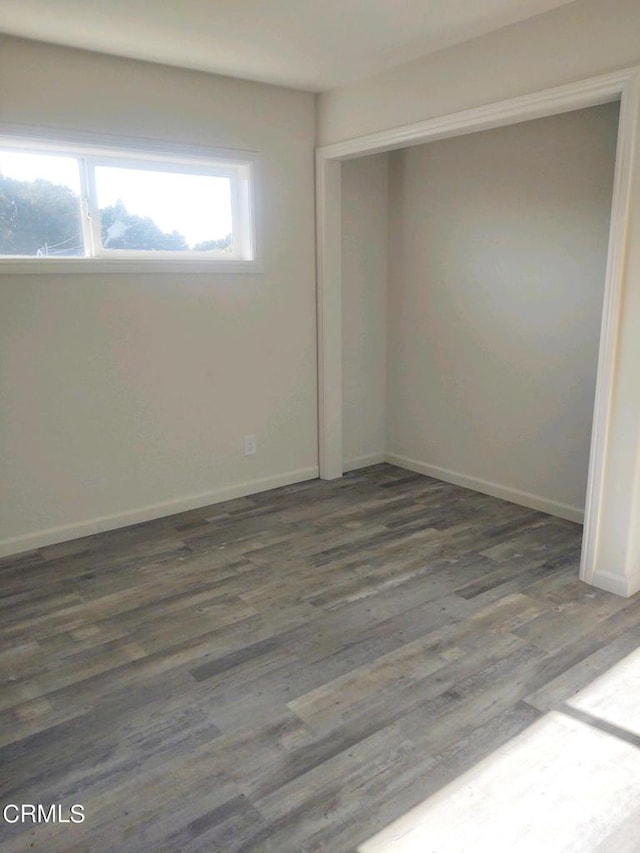 spare room featuring dark hardwood / wood-style flooring