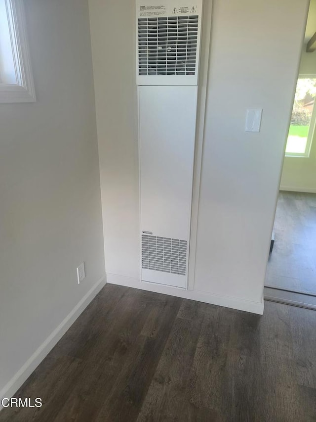 spare room with dark wood-type flooring