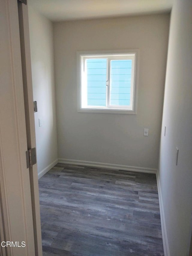 spare room featuring dark wood-type flooring