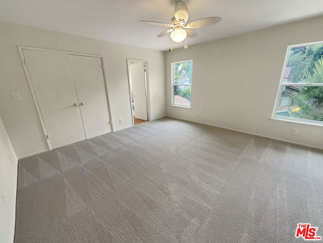 unfurnished bedroom featuring ceiling fan and light carpet