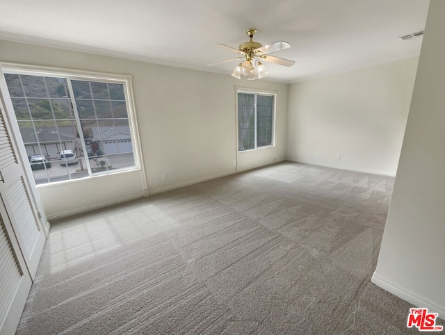 empty room with light carpet and ceiling fan