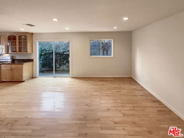 unfurnished living room featuring light hardwood / wood-style floors