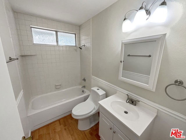 full bathroom with wood-type flooring, vanity, toilet, and tiled shower / bath