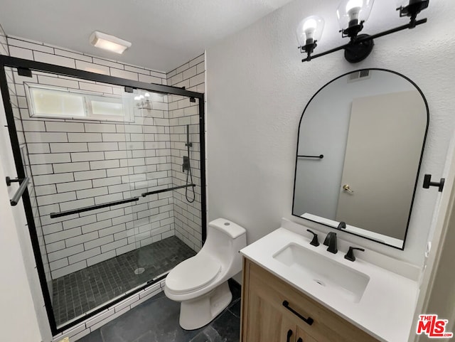 bathroom featuring a shower with door, vanity, and toilet