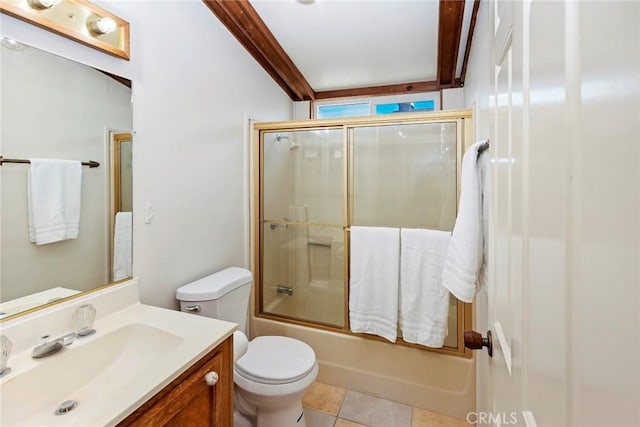 full bathroom featuring combined bath / shower with glass door, vanity, tile patterned floors, and toilet