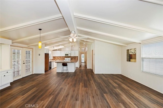 unfurnished living room featuring french doors, lofted ceiling with beams, dark hardwood / wood-style floors, and ceiling fan