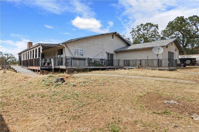 view of side of property with a deck