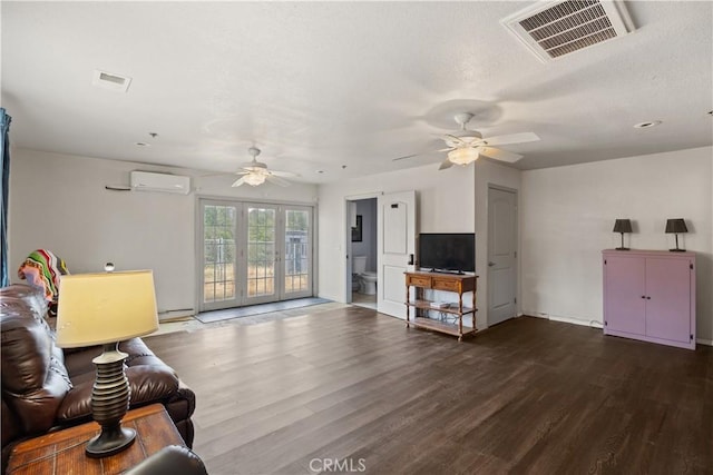 living room featuring a wall mounted AC, ceiling fan, and dark hardwood / wood-style floors