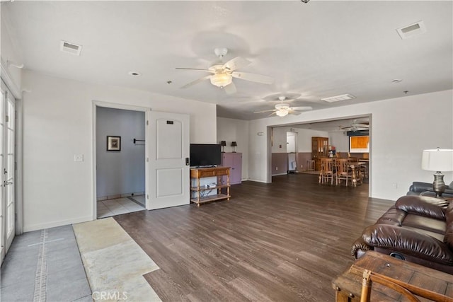 living room featuring dark hardwood / wood-style floors and ceiling fan