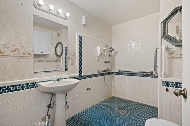 bathroom featuring a tile shower and tile walls