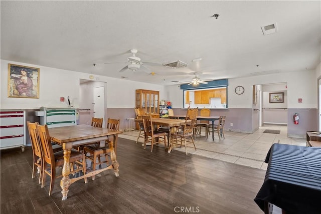 dining room with hardwood / wood-style flooring and ceiling fan