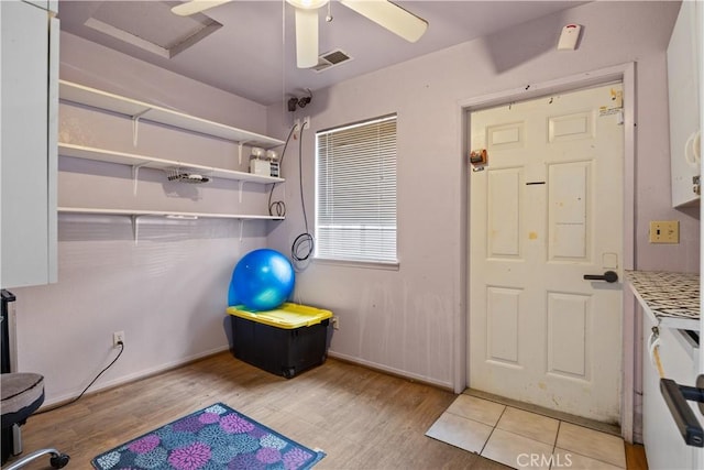 interior space with light wood-type flooring and ceiling fan