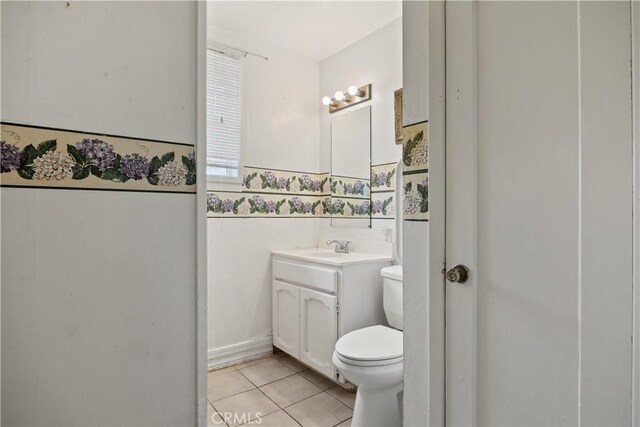 bathroom featuring tile patterned floors, vanity, and toilet