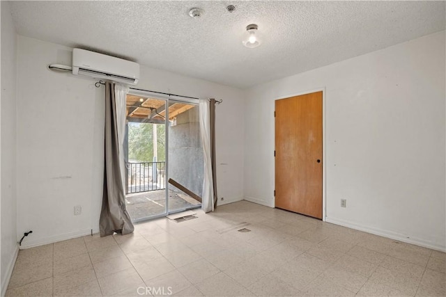 unfurnished room with a textured ceiling and a wall mounted AC