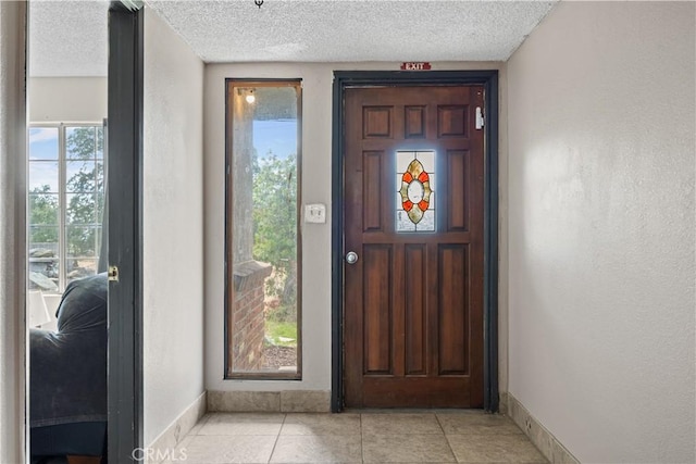 tiled entrance foyer with a textured ceiling