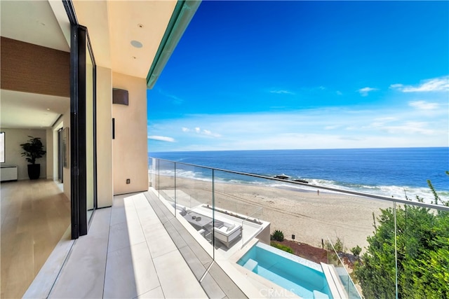 balcony with a view of the beach and a water view