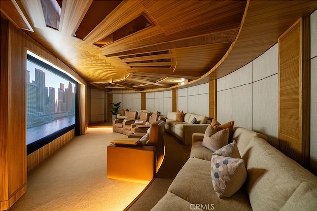 cinema room with wood walls, wood ceiling, and light carpet