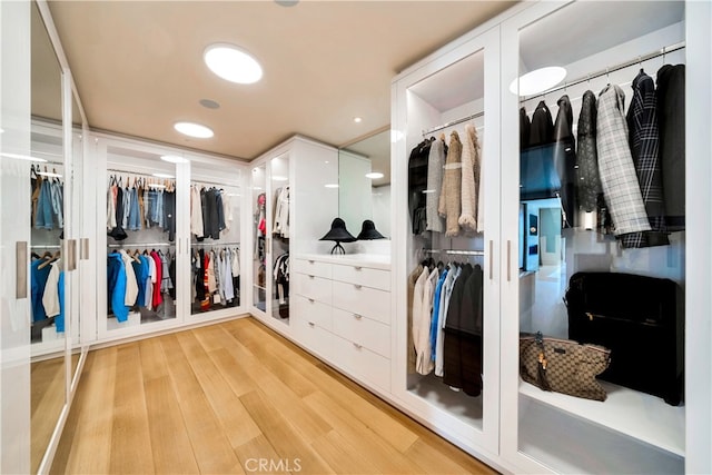 walk in closet featuring light hardwood / wood-style floors