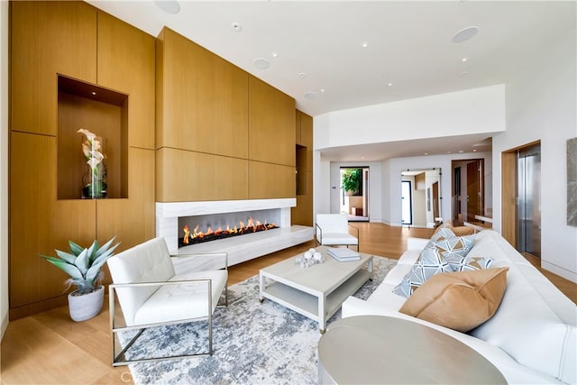 living room with light hardwood / wood-style flooring and elevator