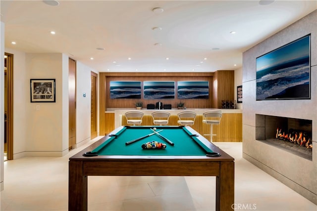 recreation room with a fireplace, billiards, and light tile patterned floors