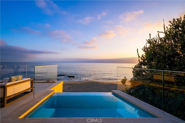 pool at dusk with a water view