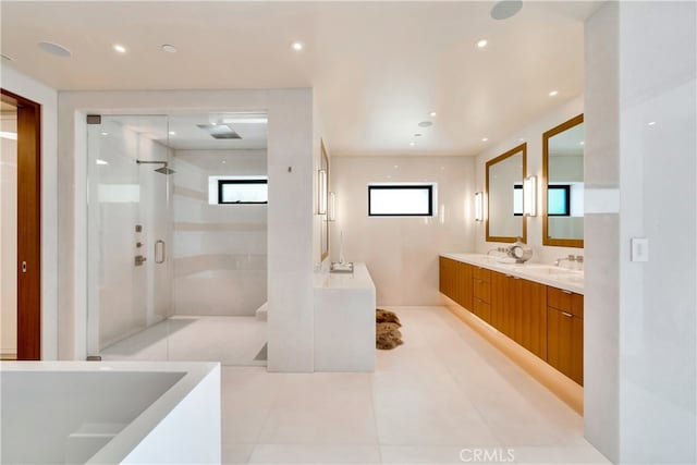 bathroom featuring tile patterned flooring, a healthy amount of sunlight, shower with separate bathtub, and dual bowl vanity