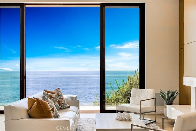 living room with floor to ceiling windows and a water view