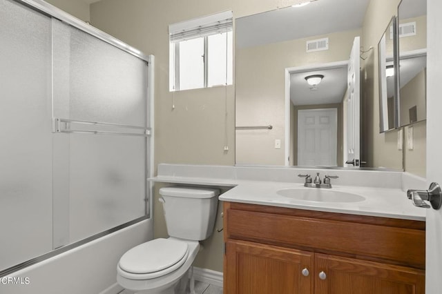 full bathroom featuring vanity, toilet, and bath / shower combo with glass door