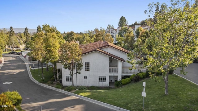 view of side of home with a yard