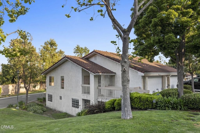 view of side of property with a yard and a garage