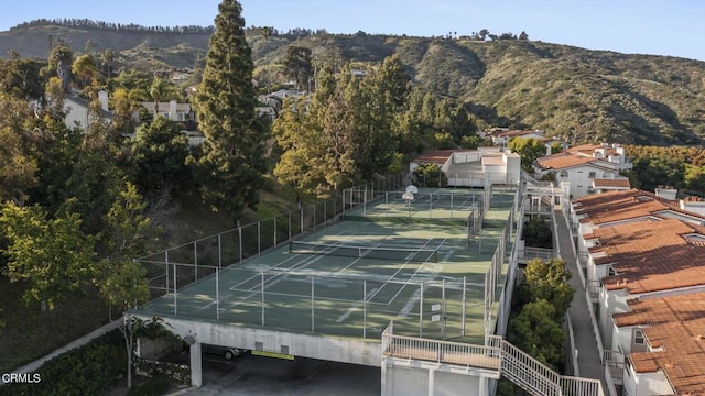 view of tennis court with a mountain view