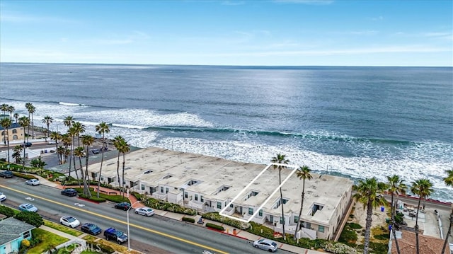 bird's eye view featuring a water view and a beach view