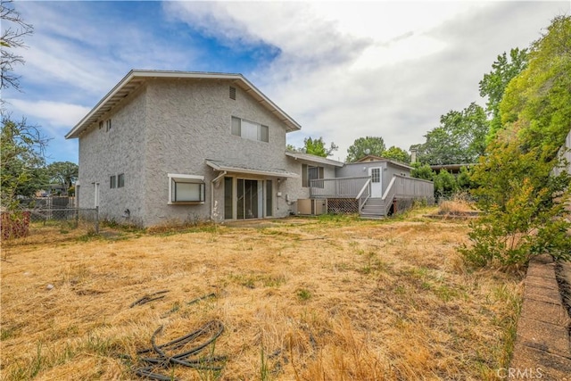 back of house featuring a wooden deck and central AC