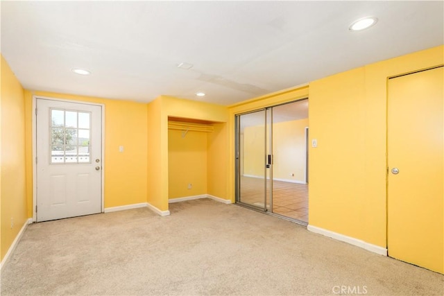 unfurnished bedroom featuring multiple closets and carpet floors