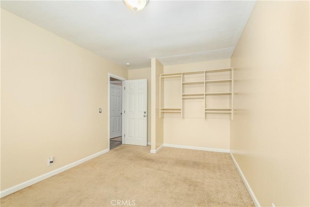 unfurnished bedroom with light colored carpet and a closet