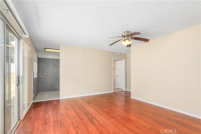 unfurnished room with hardwood / wood-style floors, a textured ceiling, and ceiling fan