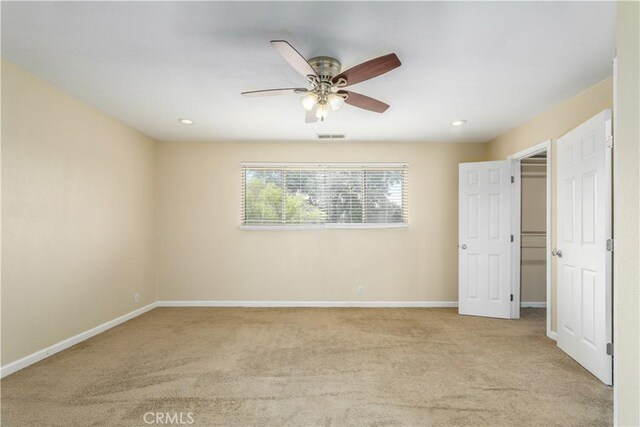 carpeted empty room with ceiling fan