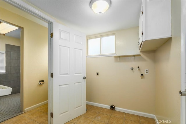 clothes washing area featuring hookup for an electric dryer, light tile patterned flooring, cabinets, and washer hookup