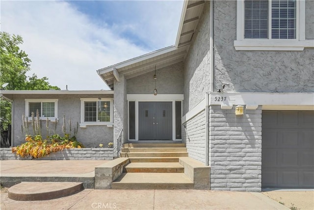 doorway to property with a garage