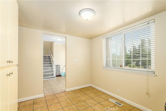 unfurnished room with light tile patterned floors