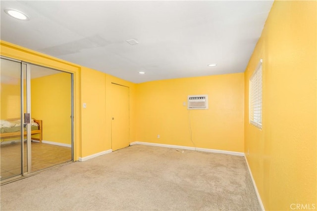 unfurnished room with carpet flooring and a wall mounted air conditioner